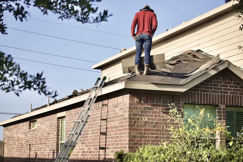 Professional roofer working on a residential roof in Goshen